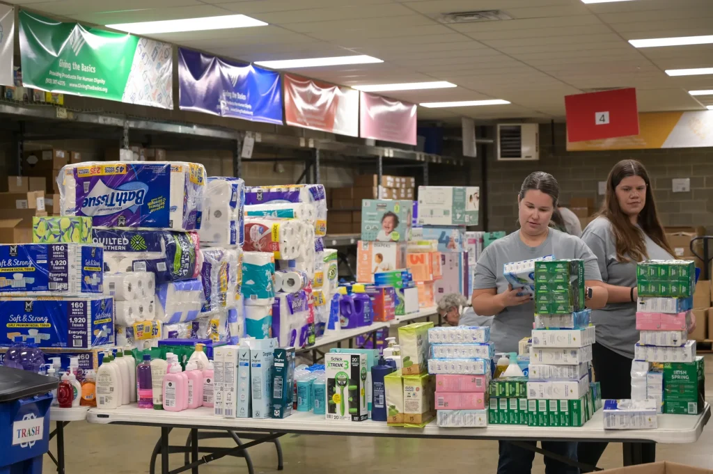 Tables of donated hygiene products at the Giving the Basics warehouse